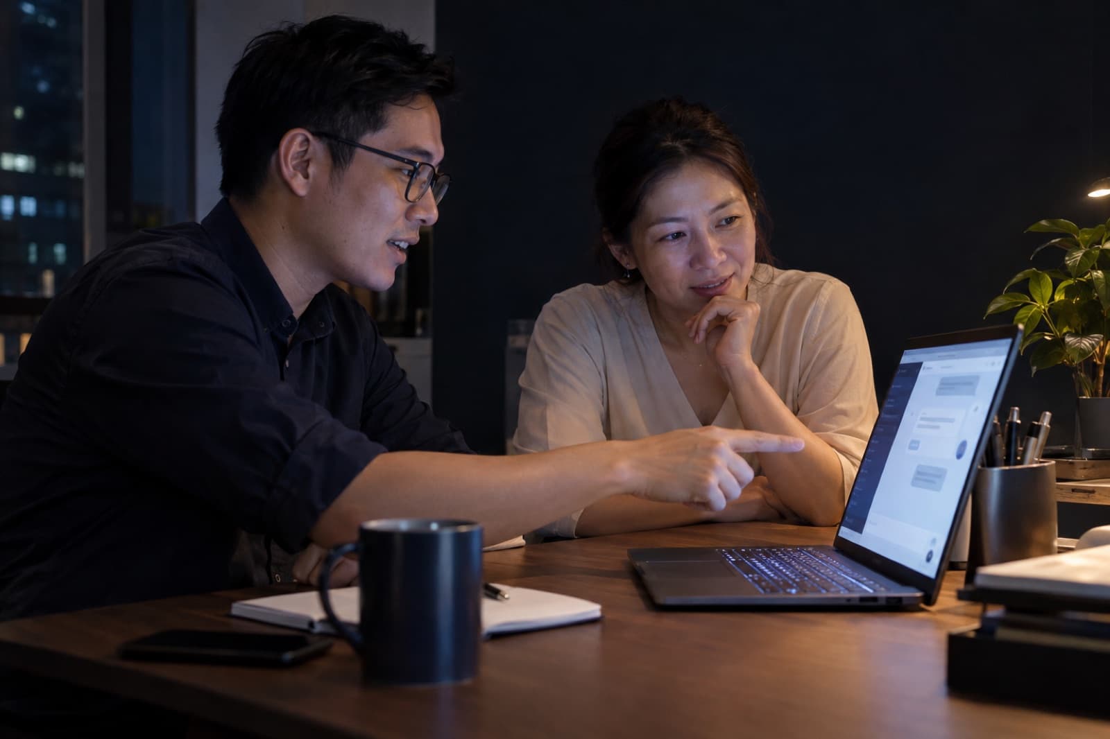 An AI advisor walking a client through an AI assistant on a laptop